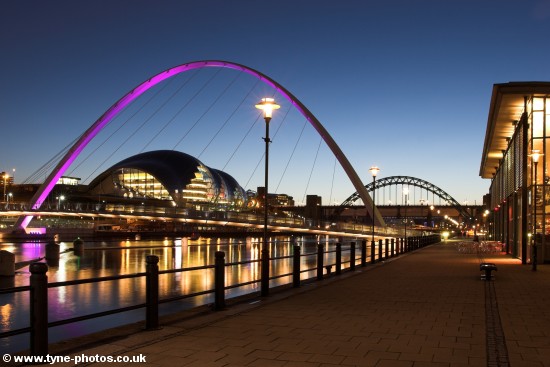 Evening view along the Quayside showing the Millennium Bridge and Tyne Bridge.