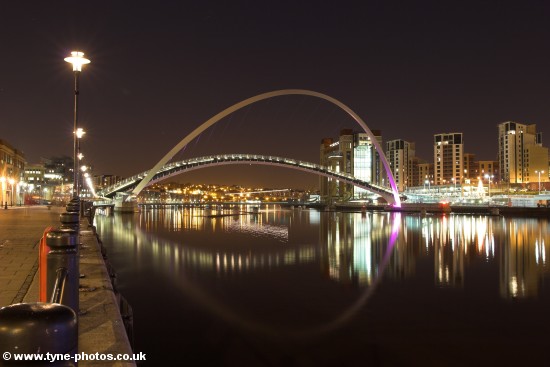 Night view along the Quayside to the Millennium Bridge seen here in the open position.