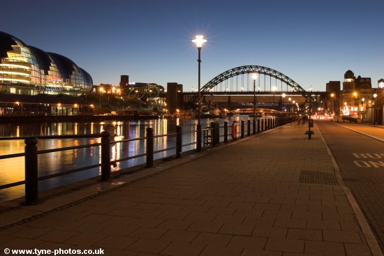 Evening view along the Quayside to the Tyne Bridge and across the River Tyne to the Sage Gateshead.