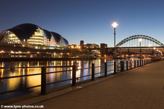 Evening view along the Quayside to the Tyne Bridge and across the River Tyne to the Sage Gateshead.