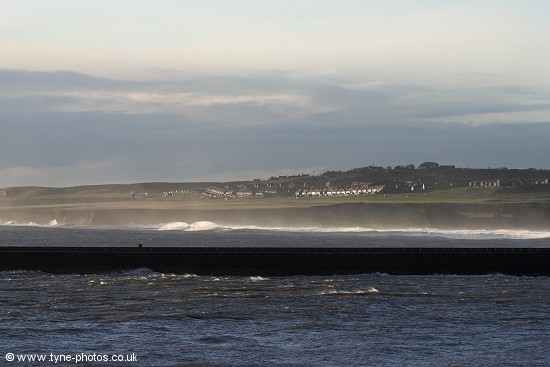 Looking over the River Tyne and South Shields Pier to waves breaking onto the beach.