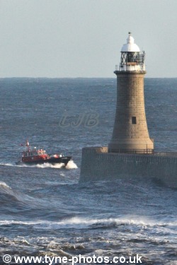 Tyne Pilot Boat Norman Forster riding the waves past Tynemouth Lighthouse.