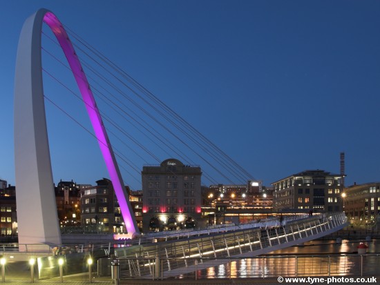 Millennium Bridge with purple lighting.