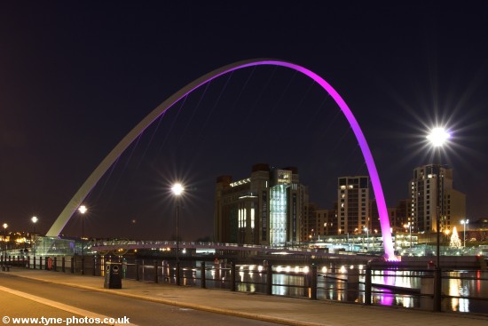 Millennium Bridge seen changing colour from purple to red.