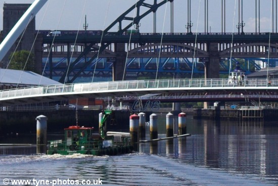 Small barge passing under the Millennium Bridge shortly before it started to open.