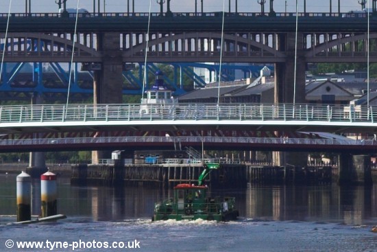 Small barge passing under the Millennium Bridge shortly before it started to open.