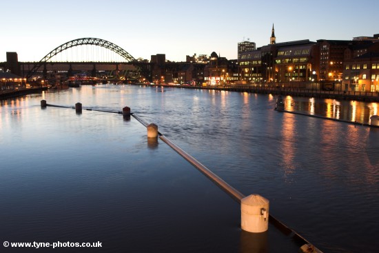 Evening view along the River Tyne to the Tyne Bridge and Quayside, seen from the Millennium Bridge.