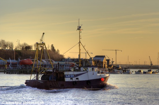 Fishing boat Barbara Anne sailing up the RiverTyne at sunset.