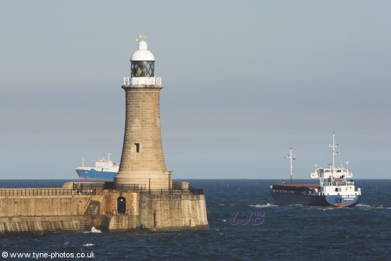 Cargo Ship Sea Box passing Tynemouth Lighthouse and Pier.