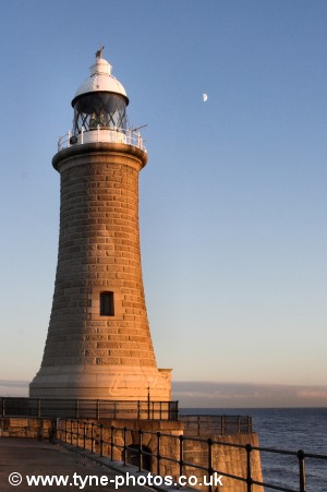 The lighthouse with the moon behind it.