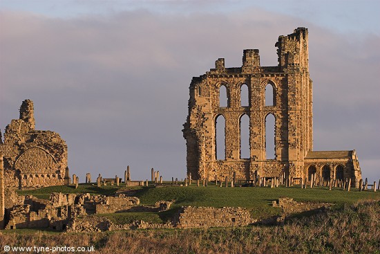 Tynemouth Priory Ruins glowing in early morning sunlight.