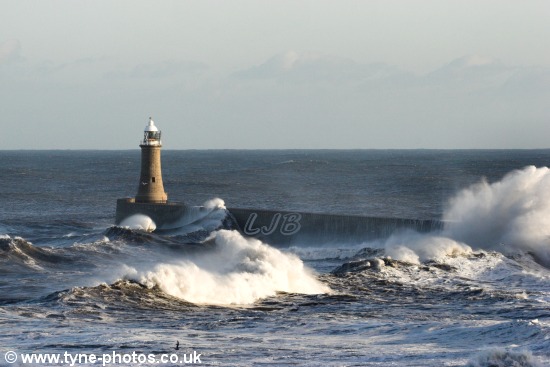 Waves breaking over Tynemouth Pier on a stormy day.
