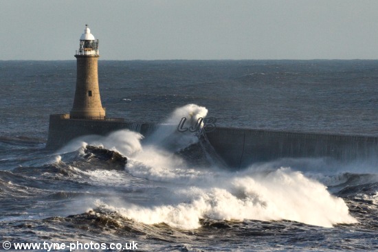 Waves breaking over Tynemouth Pier on a stormy day.