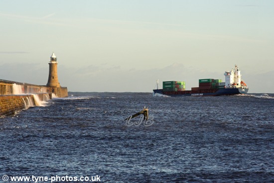 Between the piers and pitching in the swell.