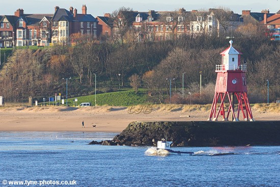 Small boat passing Herd Groyne on it's way out to sea.
